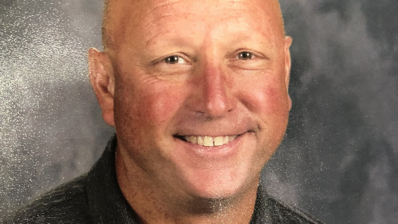 Headshot of bald white man smiling