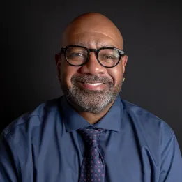 Black man wearing glasses with beard