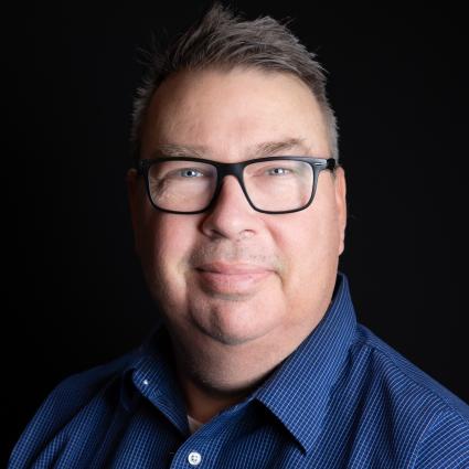 Caucasian man with brown hair wearing glasses