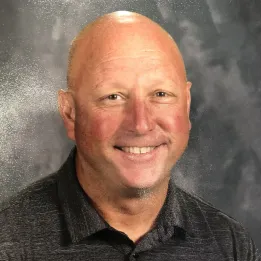 Headshot of bald white man smiling